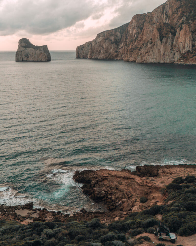 4x4 parked with a view on cliffs at the west coast of Sardinia